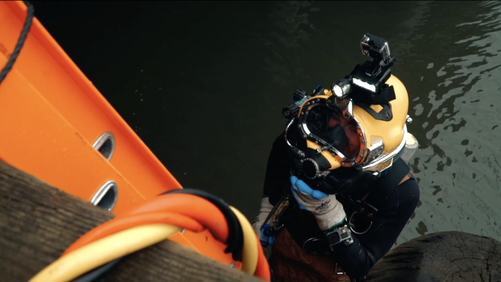 UBC Diver descending ladder into water