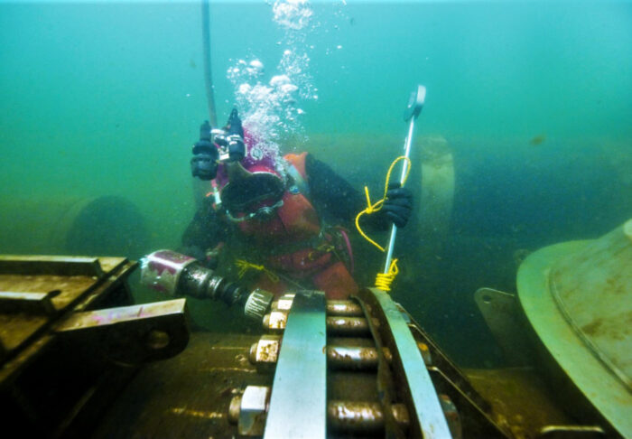 Submerged UBC Diver using wrench